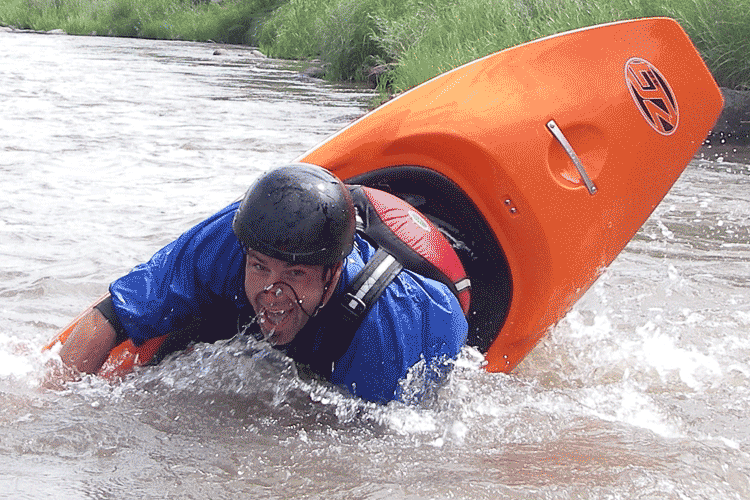 Male whitewater kayaker practicing with paddle