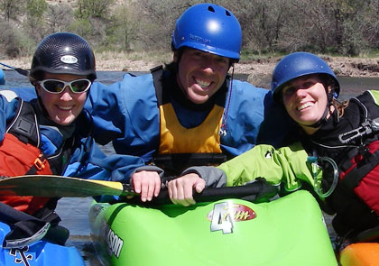 Three people in their kayaks side-by-side.